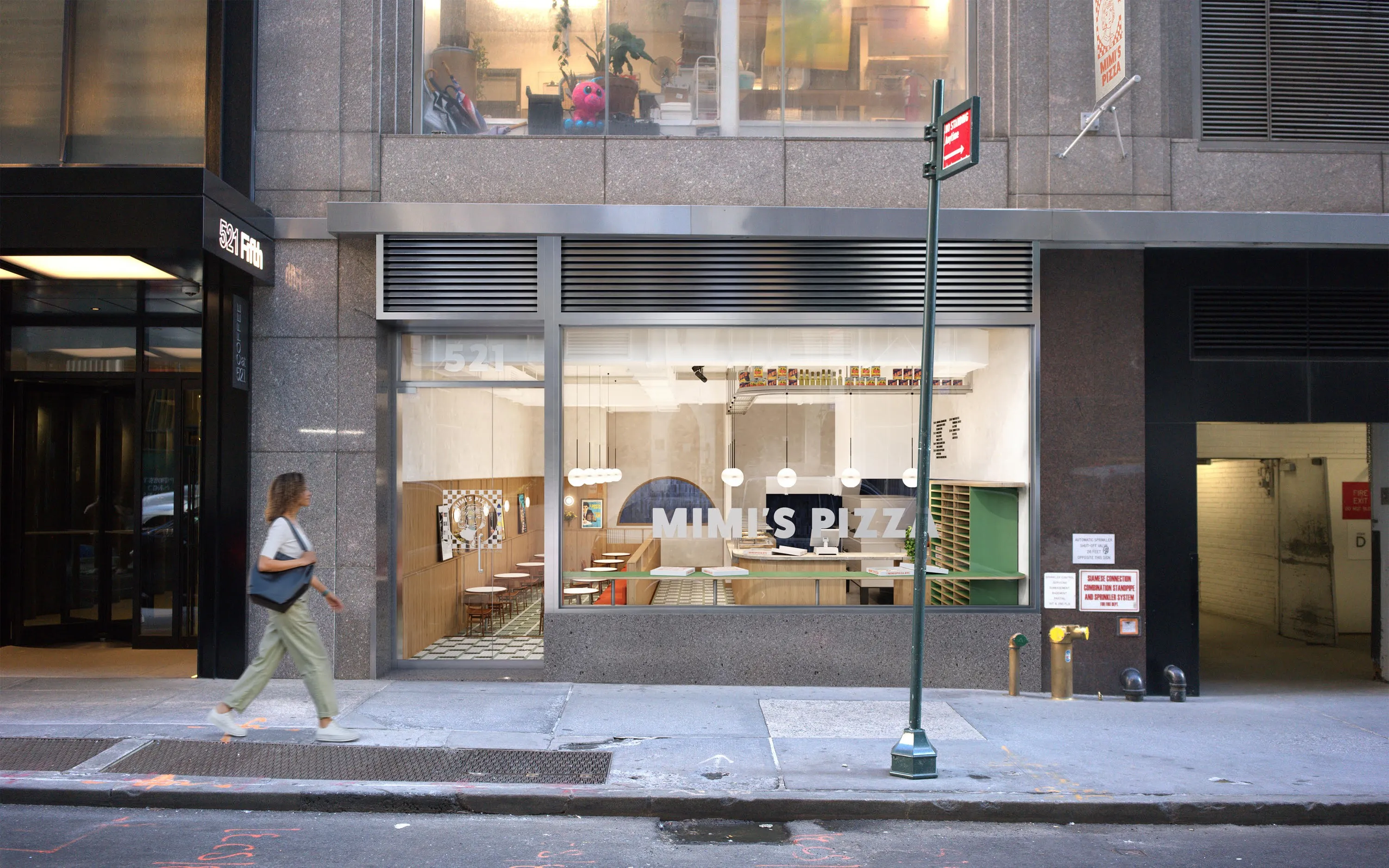 Mimi's Pizza storefront on a city street with a woman walking past