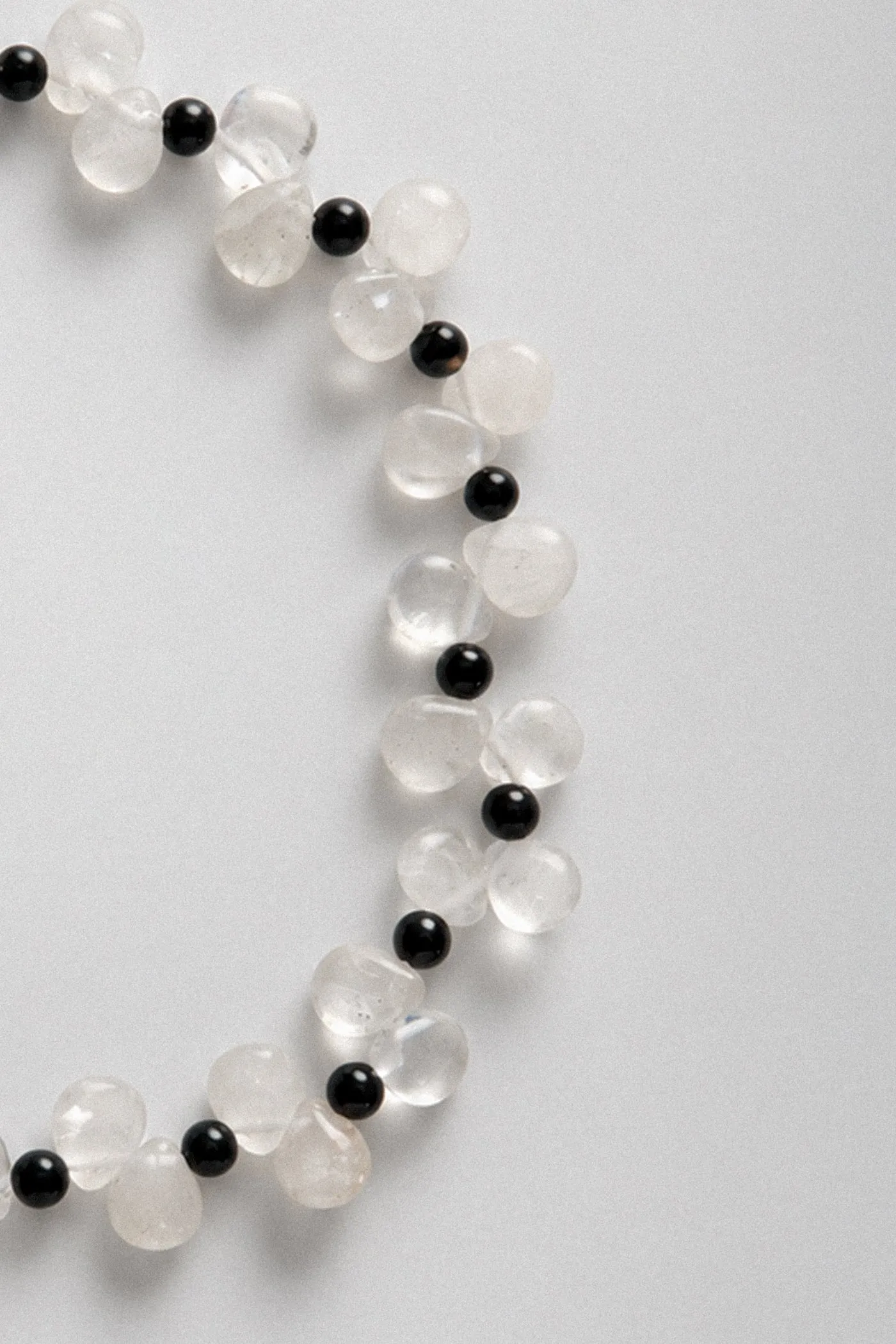 Close-up of a necklace of clear quartz and black onyx beads