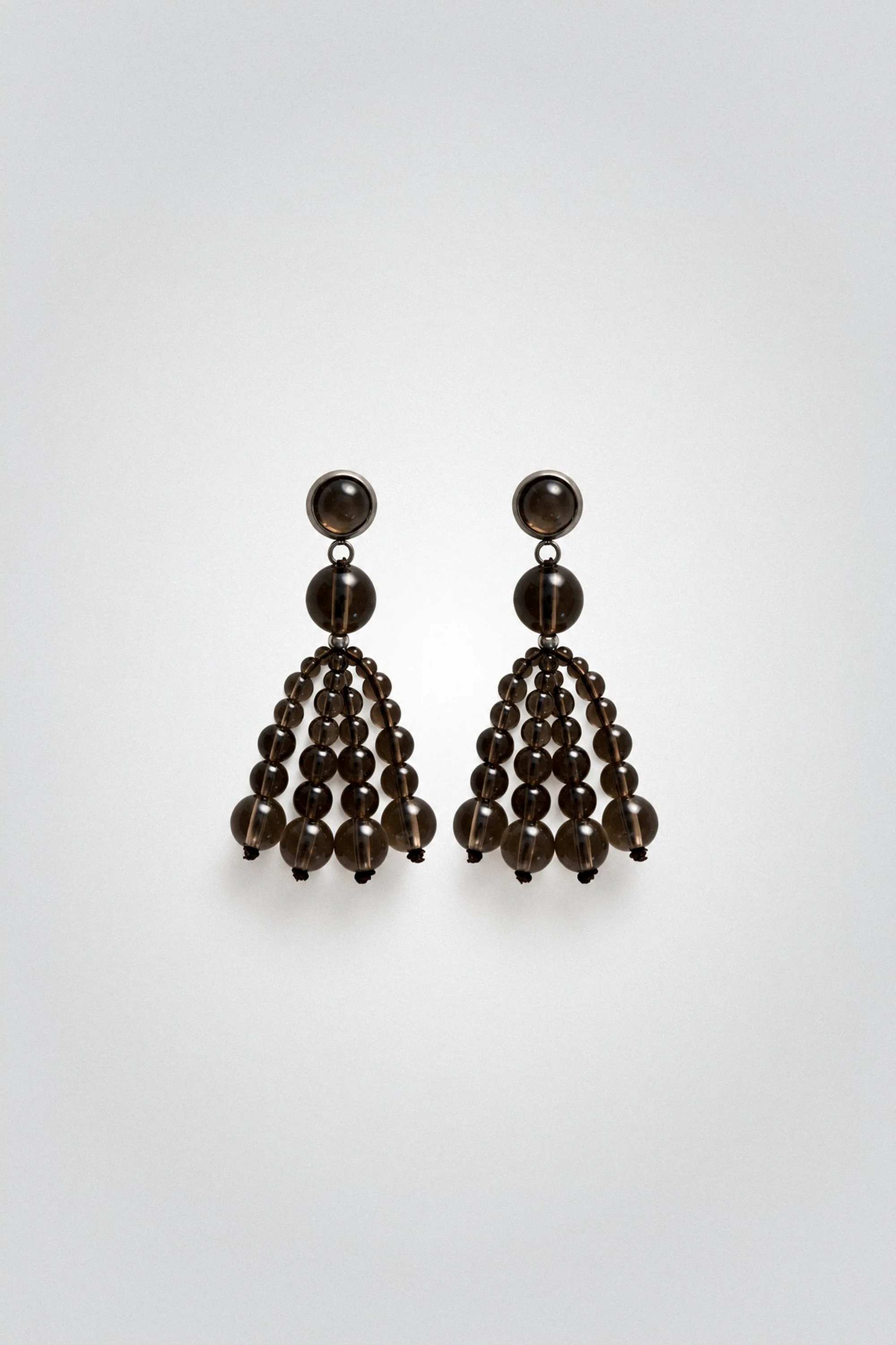 Smoky quartz beaded chandelier earrings on a grey background