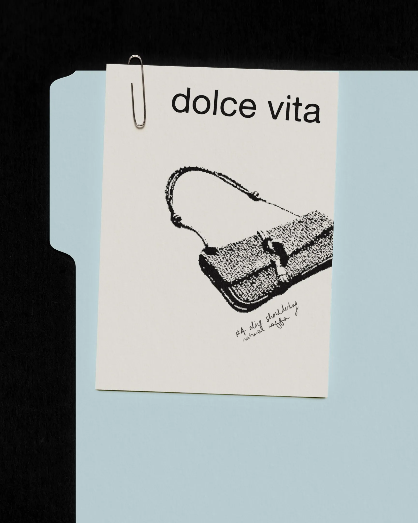 Dolce Vita post: ink drawing of a woven shoulder bag on a card clipped to a pale blue folder